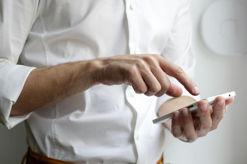 man scrolling through his phone
